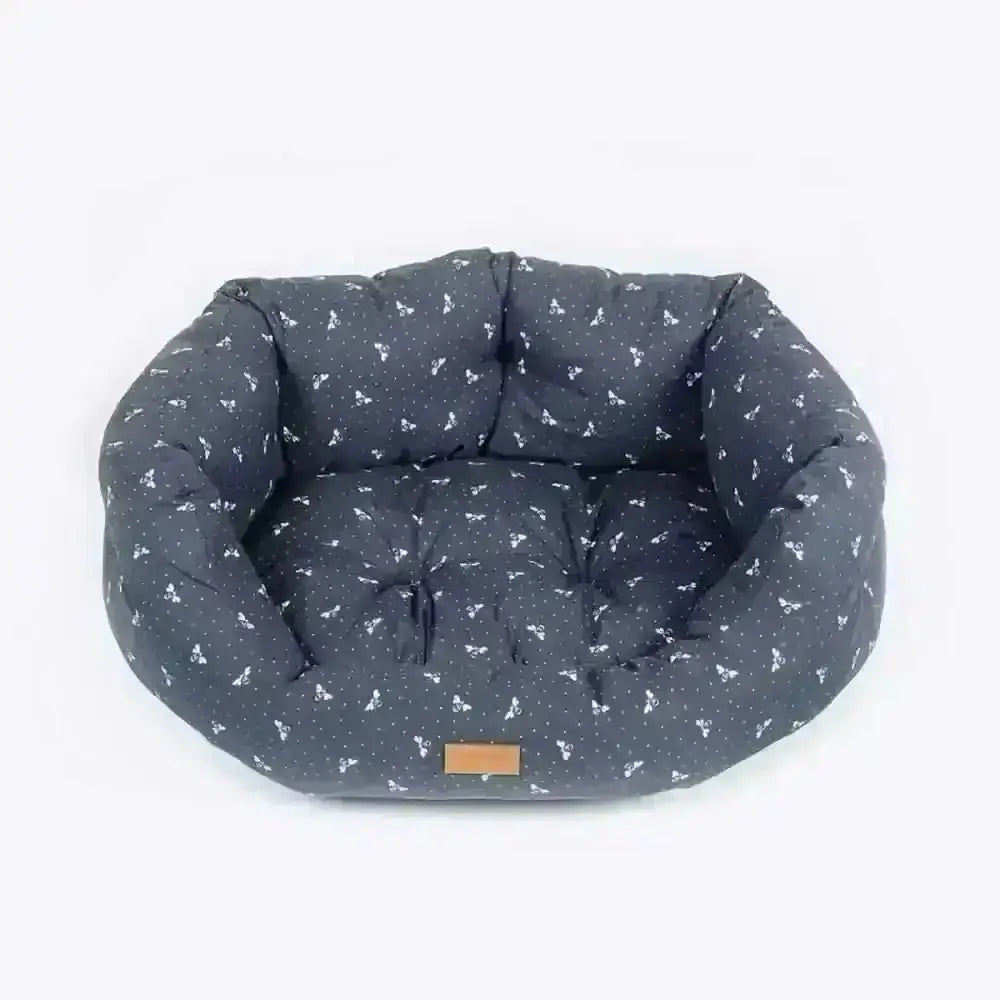 Danish Design FatFace Spotty Bees Deluxe Slumber bed in navy blue with white bone pattern, cushioned interior and brown label
