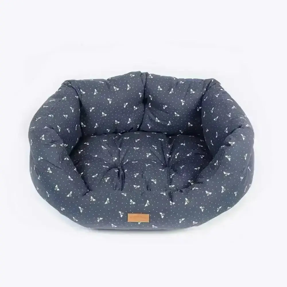 Danish Design FatFace Spotty Bees Deluxe Slumber bed in navy blue with white bone pattern, cushioned interior and brown label
