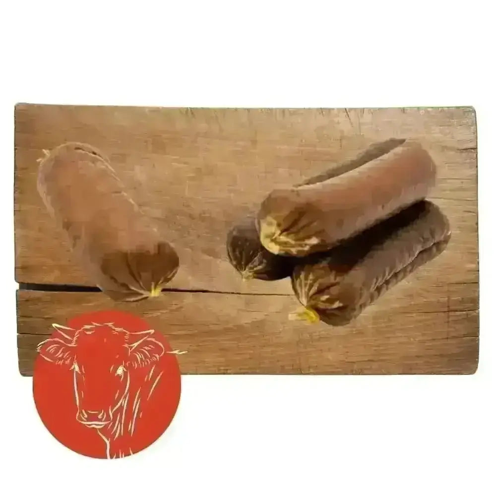 Dried beef and garlic sausage with chocolate eclair on wooden board, natural cat food