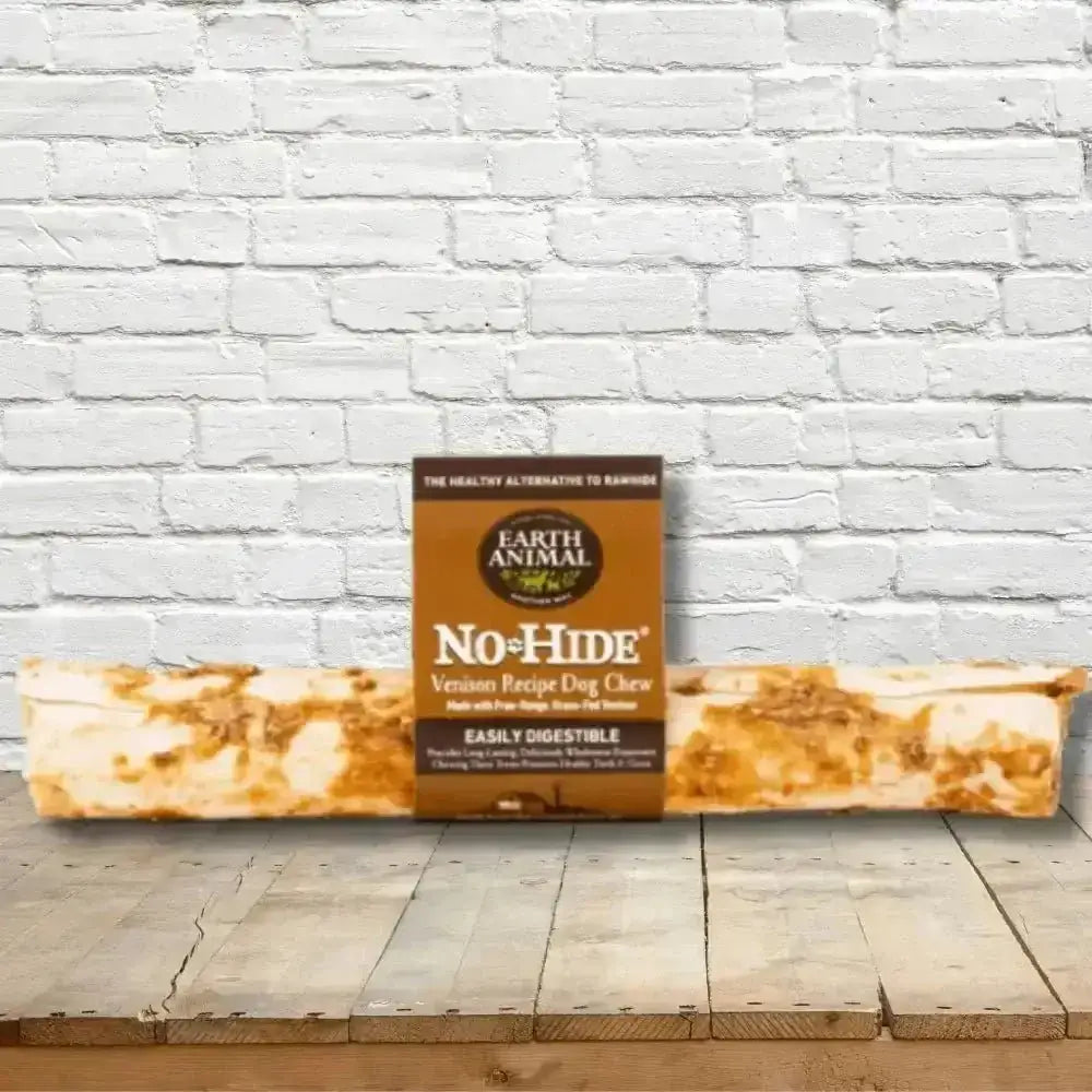 Earth Animal No-Hide Venison Chew for dogs on textured brown and white surface