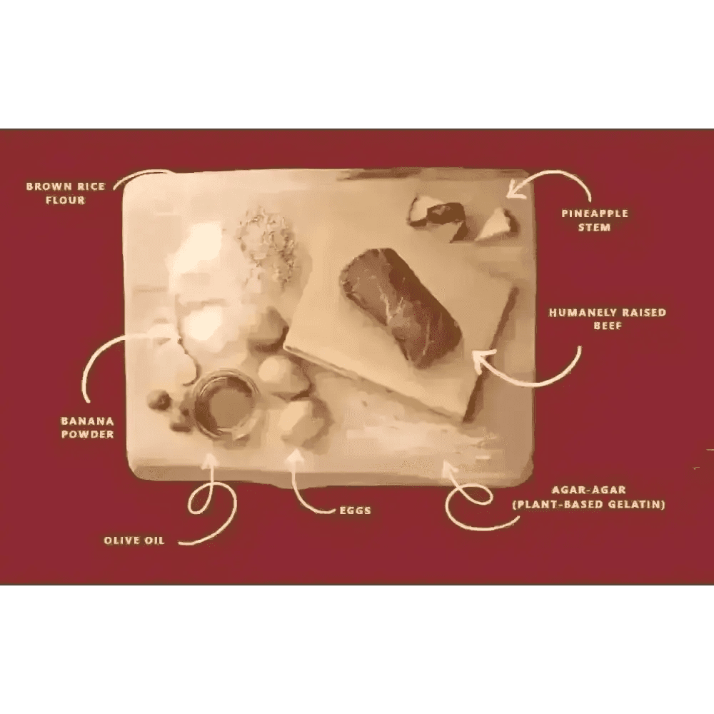 Earth Animal No-Hide beef chew on wooden cutting board with ingredients