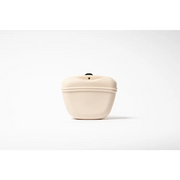 Cream-colored silicone dog treat bag with sleek curve and black top button