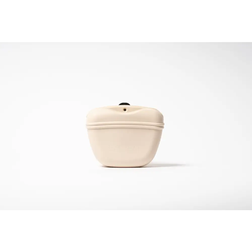 Cream-colored silicone dog treat bag with sleek curve and black top button