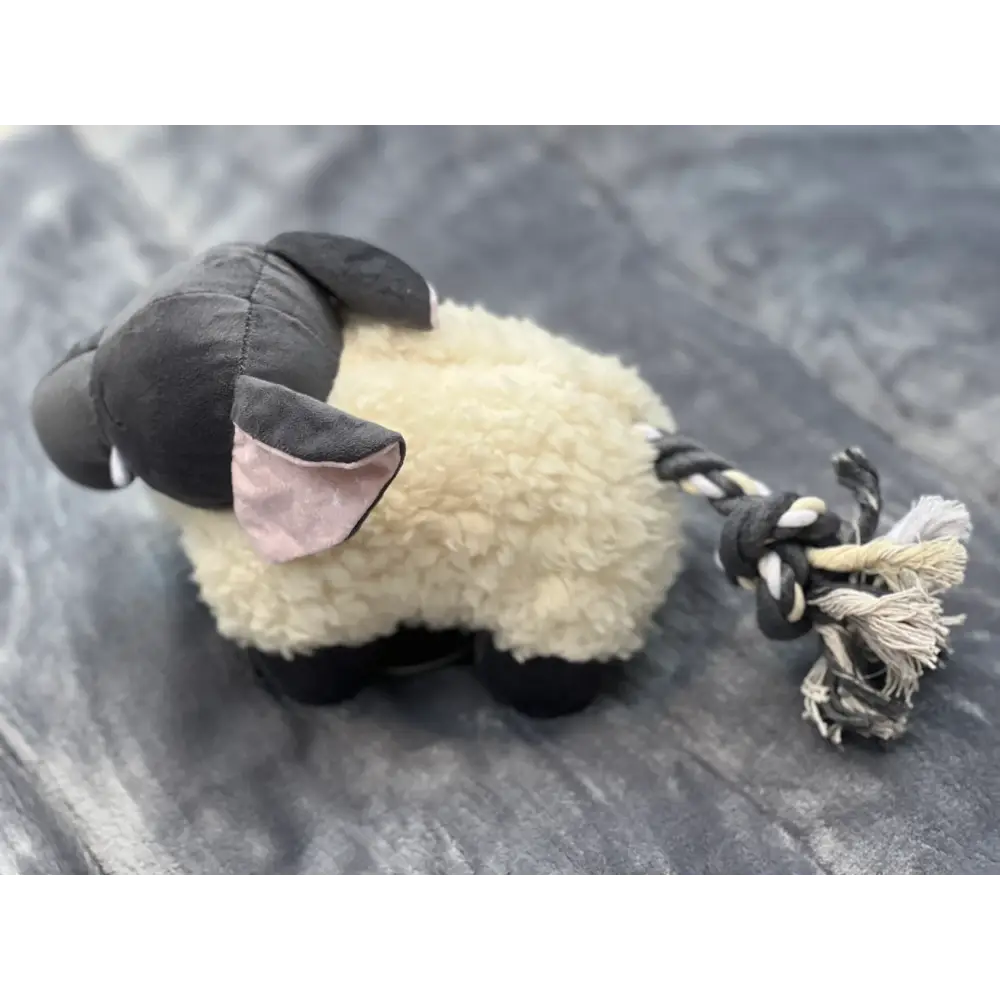 Black and white plush elephant dog toy with rope tail for playing tug, recycled materials