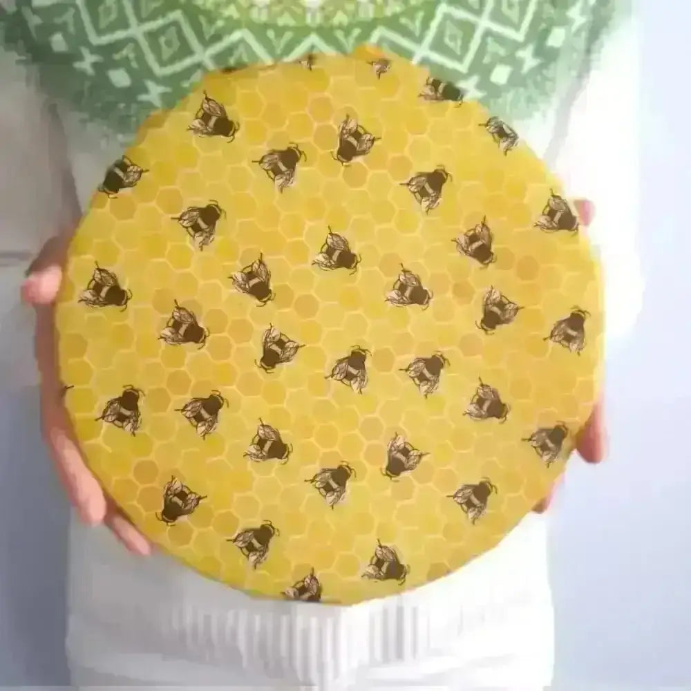 Yellow honeycomb jar lid with honey bee design from Wings family business