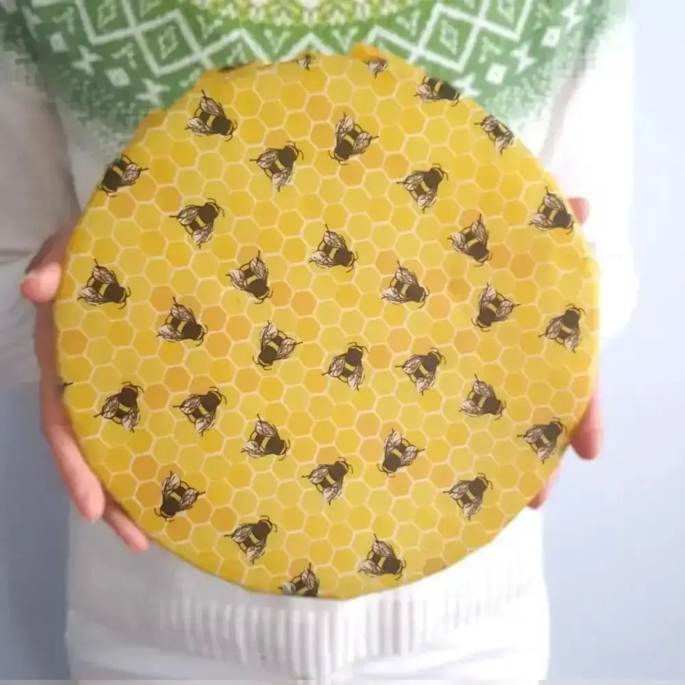 Yellow honeycomb jar lid with honey bee design from Wings family business