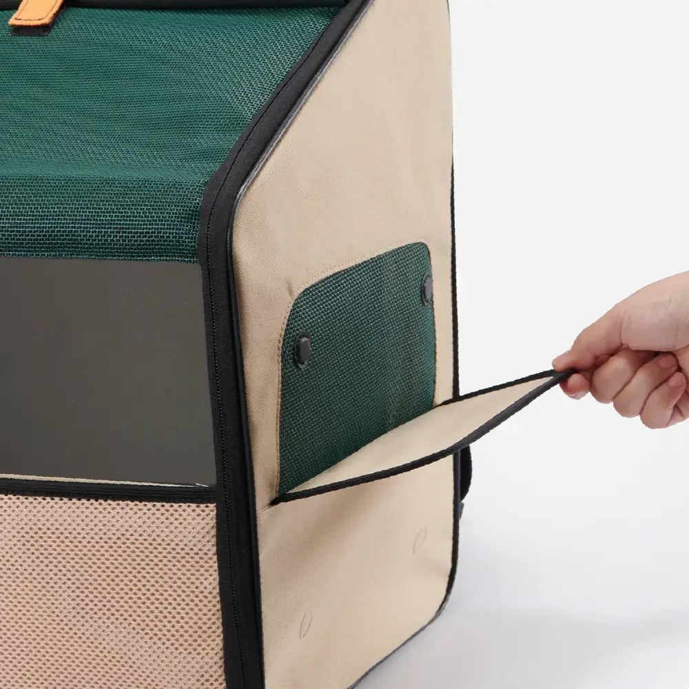 Beige and green Expandable Travel Habitat Carrier with mesh sides, black trim, orange handle for pets