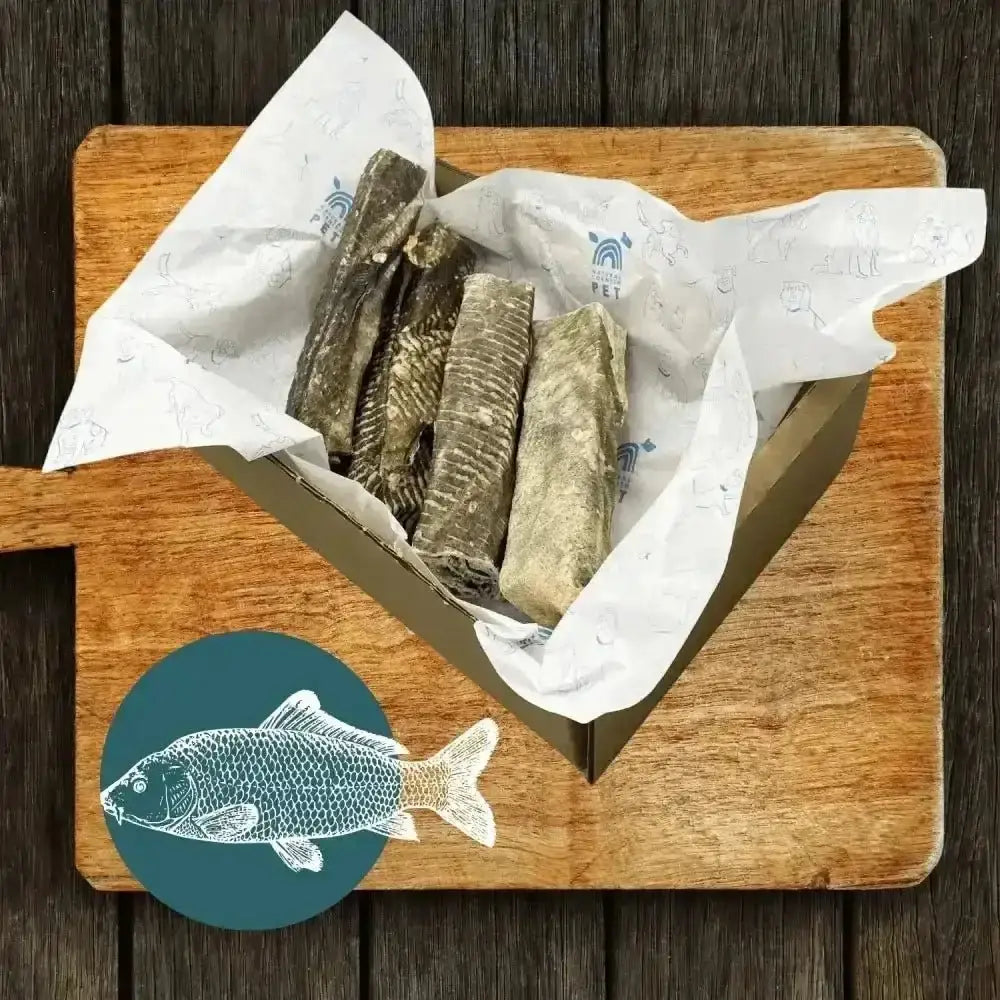 Wooden fish-shaped cutting board with wrapped cod fillets in Fish Stick Chew Box - Small