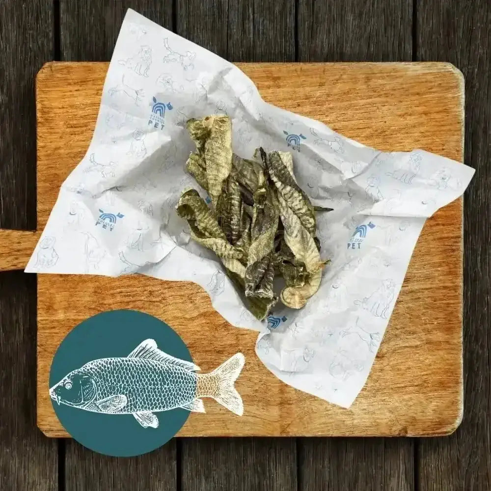 White paper with blue fish design on wooden cutting board for Fish Twirl Chew Box