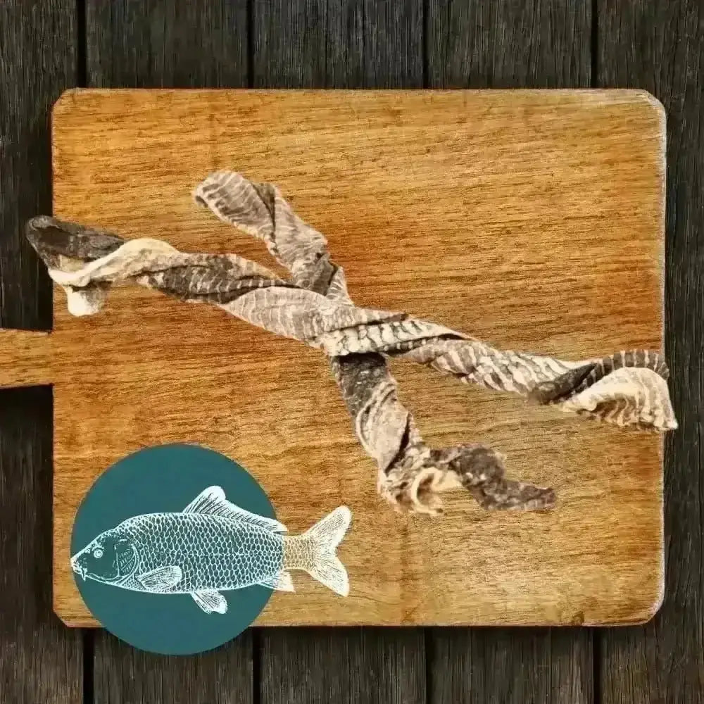 Wooden cutting board with fish design and dried squid for Fish Twirl Chew for Dogs