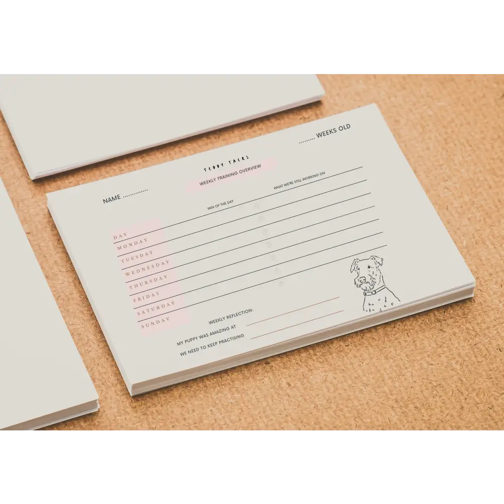 White dog-themed FREE TEDDY puppy training tracker notepad with pink accents
