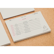 White Teddy Talks puppy routine tracker cover with pink accents and dog illustration