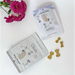 Two packages of 'Gizzls' brain booster treats for pets on a white surface with pink flowers.
