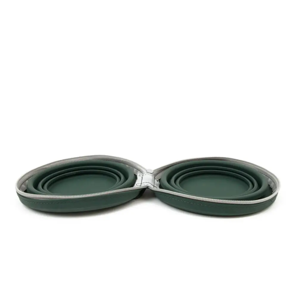 Set of two green collapsible silicone bowls in a case on a white background