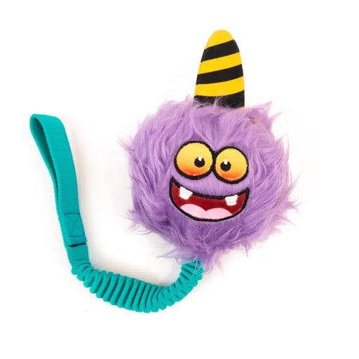 Purple fuzzy toy with a yellow and black striped hat on a white background
