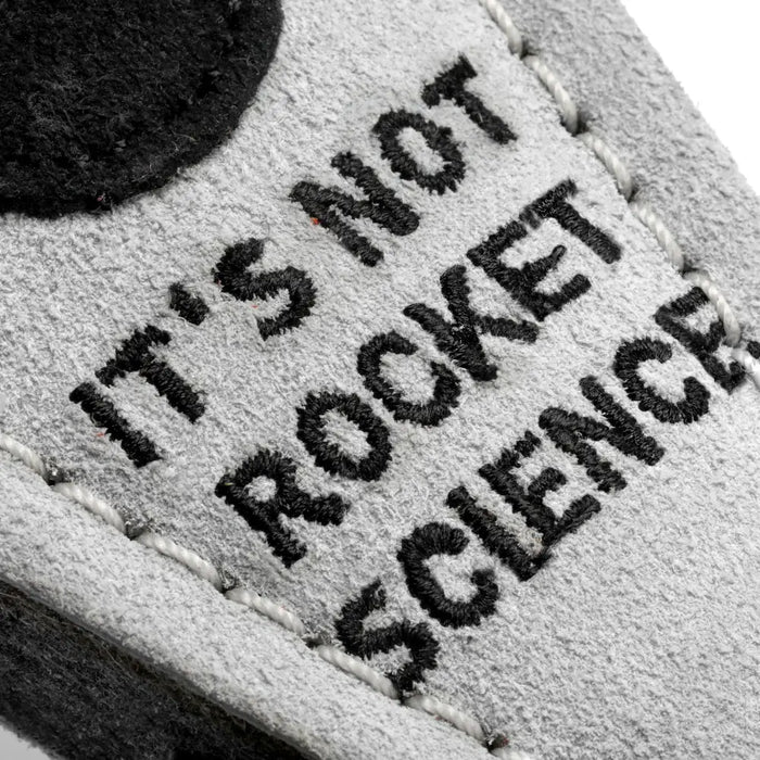 Text 'IT'S NOT ROCKET SCIENCE' on a textured surface