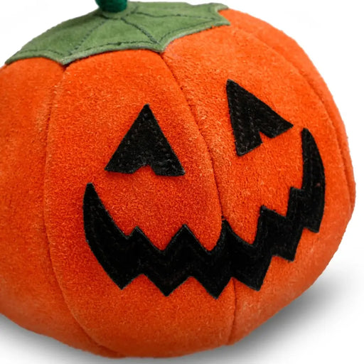 Plush pumpkin toy with jack-o'-lantern face on a white background