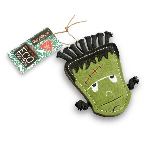 Green and black monster-shaped toy with a tag on a white background