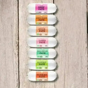 JR Pet Products Pure Pate For Dogs 400g tube with colorful labels on wood