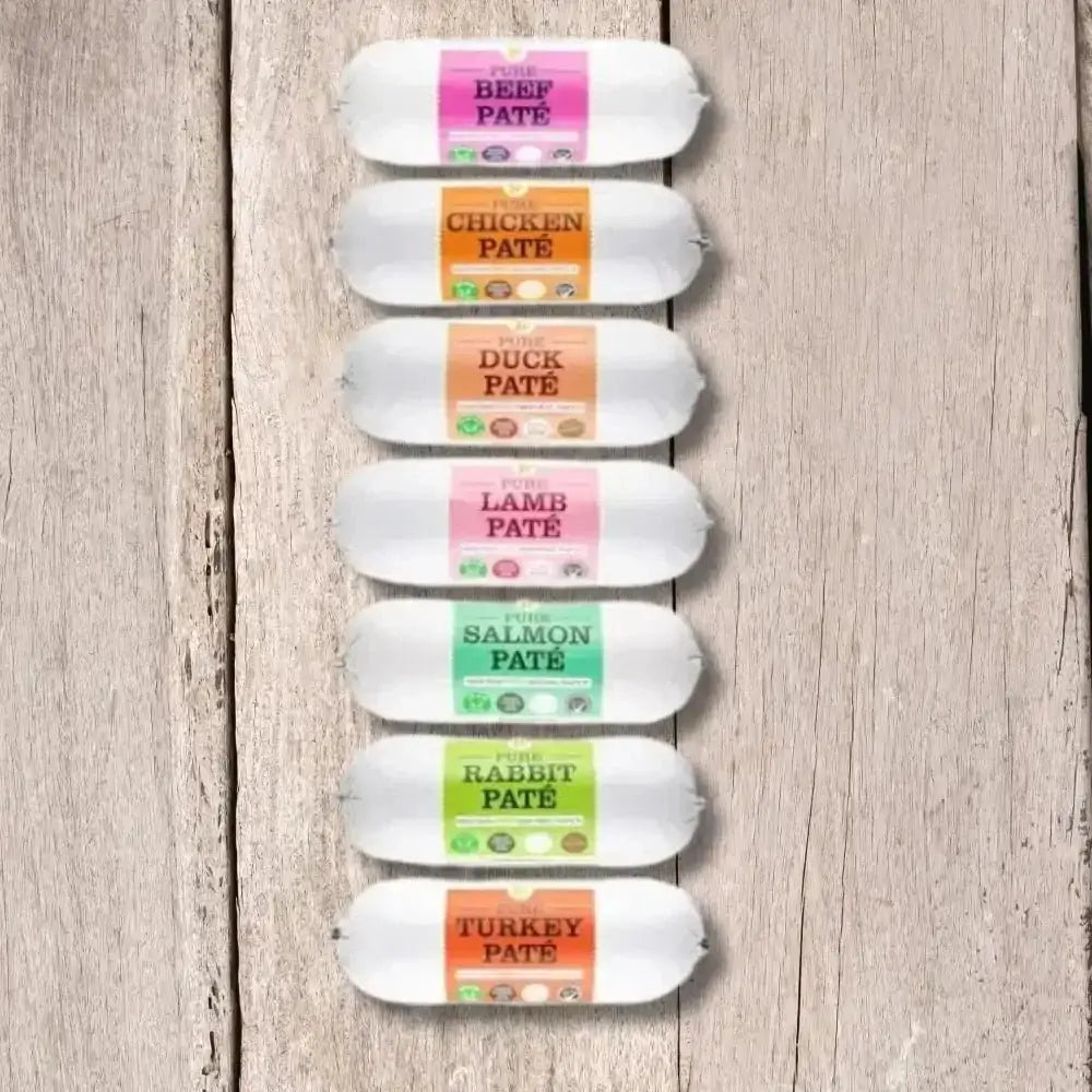 JR Pet Products Pure Pate For Dogs 400g tube with colorful labels on wood