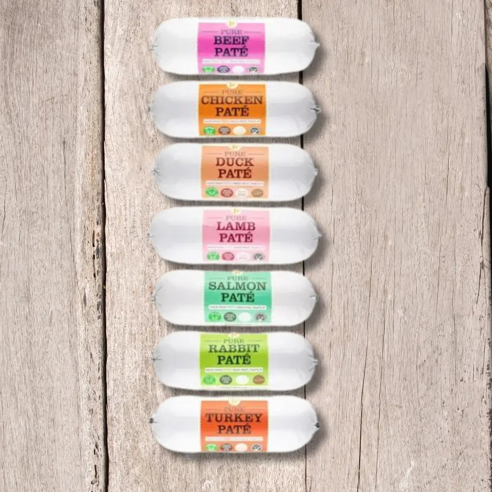 JR Pet Products Pure Pate For Dogs 400g tube with colorful labels on wood