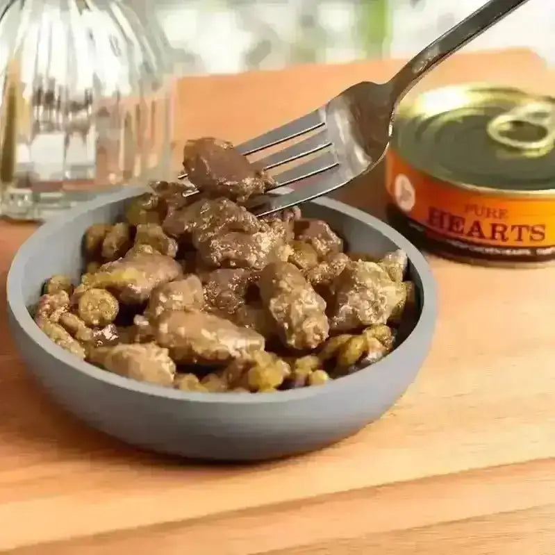 Gray bowl of JR Pure Chicken Hearts Topper with fork holding pure meat toppers