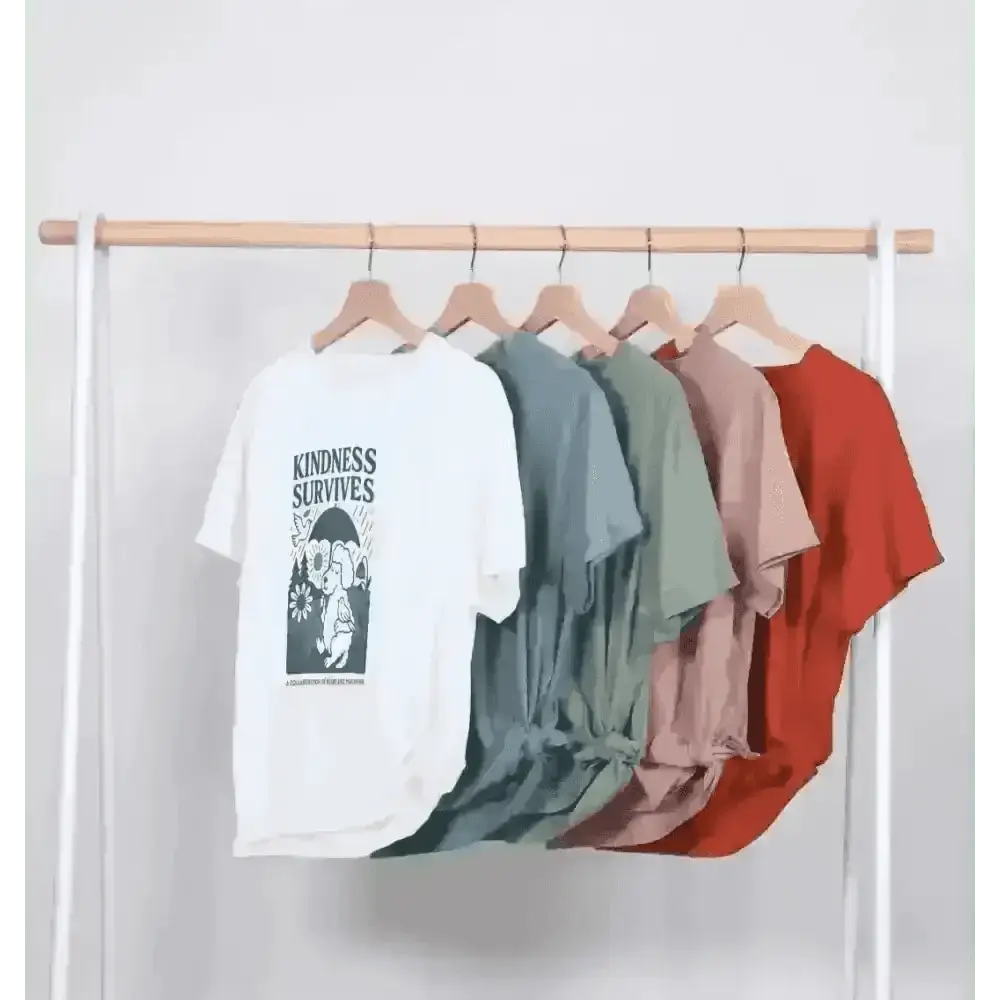 White kindness survives organic cotton T-shirt with colorful sleeves on wooden hanger