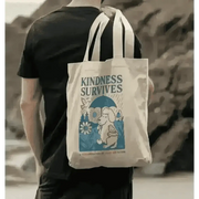 Cream-colored tote bag with elephant and bird design and kindness survives text front