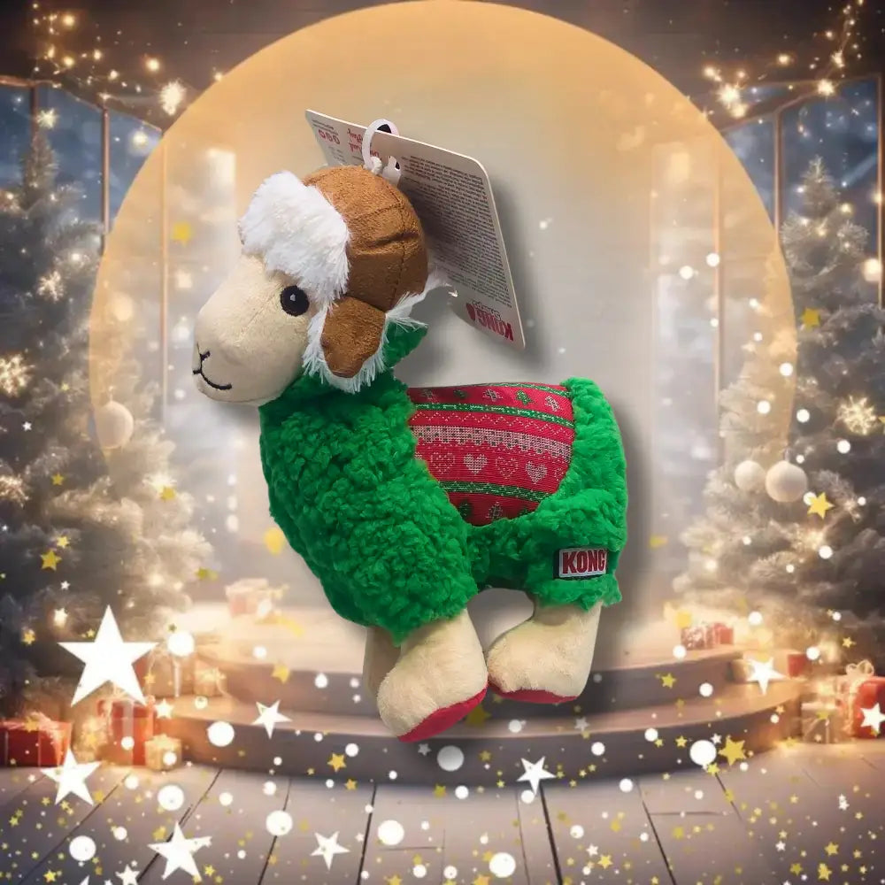 KONG Holiday Sherps Llama Christmas Toy for Dogs sits on a festive background