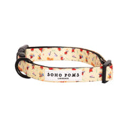 Cream-colored Soho Poms Moomins Yellow Sunrise dog collar with playful red and blue pattern