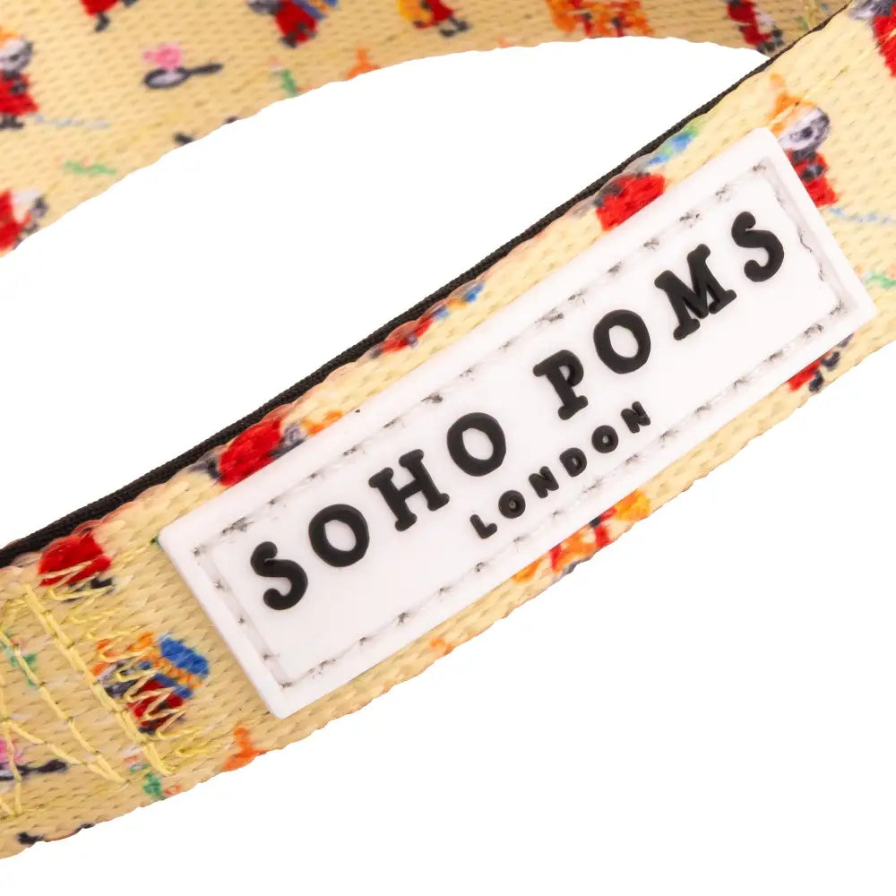 Yellow floral patterned bow tie with Soho Poms label on Moomins Yellow Sunrise Dogs Collar