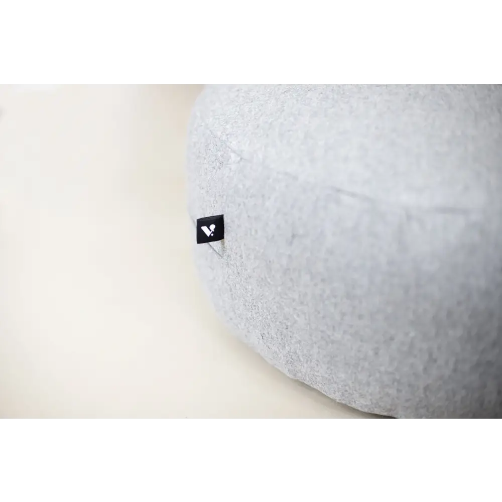 Gray concrete floor cushion with black logo, ideal for comfortable seating and relaxation