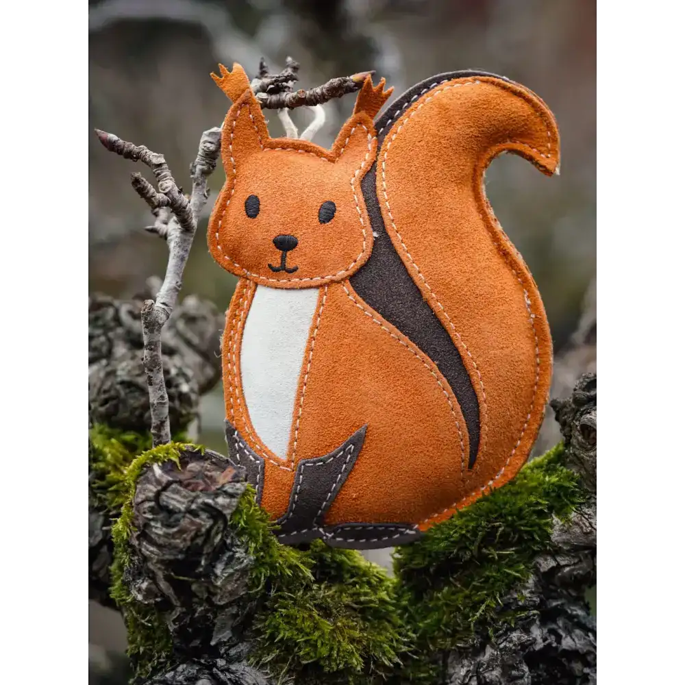 Orange felt squirrel ornament with white belly and black stitched details.
