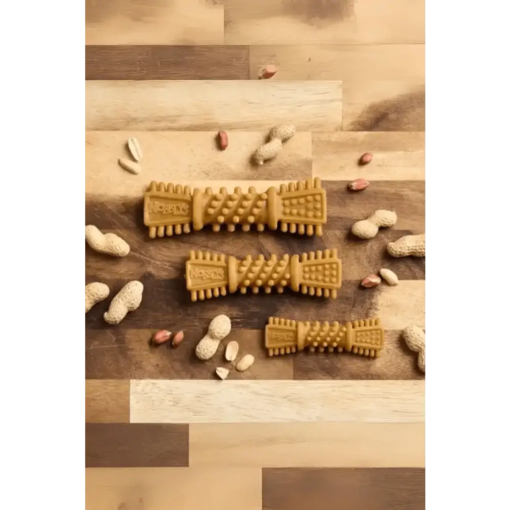 Golden textured Petello Nobblys Tough Brush dog chew toy with peanut shells and peanut butter
