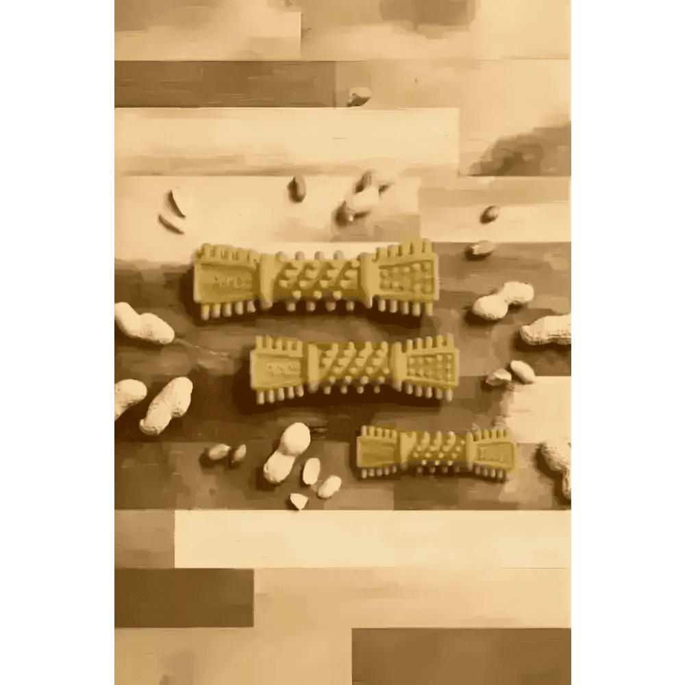 Golden textured Petello Nobblys Tough Brush peanut butter dog chew with scattered peanut shells