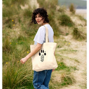 Organic cotton shopper bag with black paw print and girl who loves paws text
