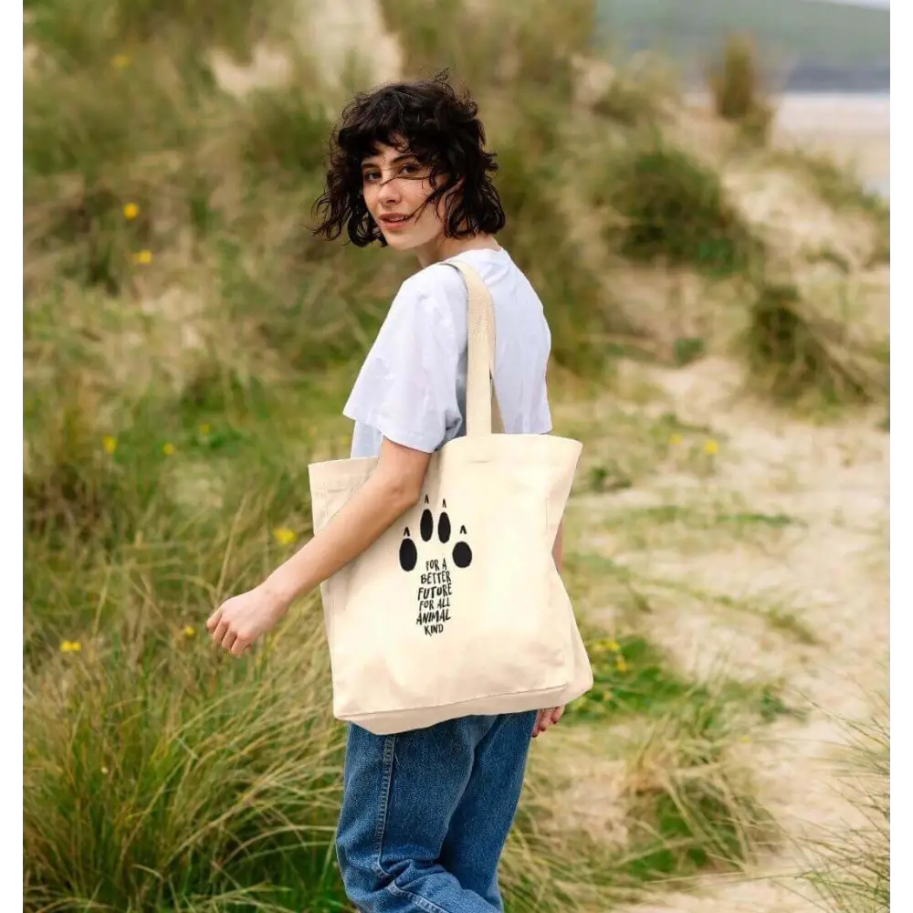 Organic cotton shopper bag with black paw print and girl who loves paws text