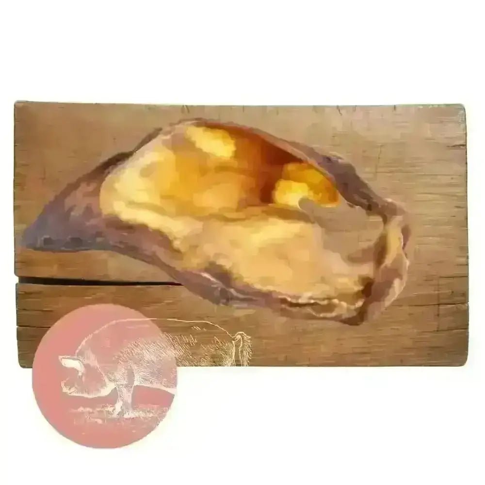 Golden pig-shaped natural dog chew from Pets Larder on wooden board