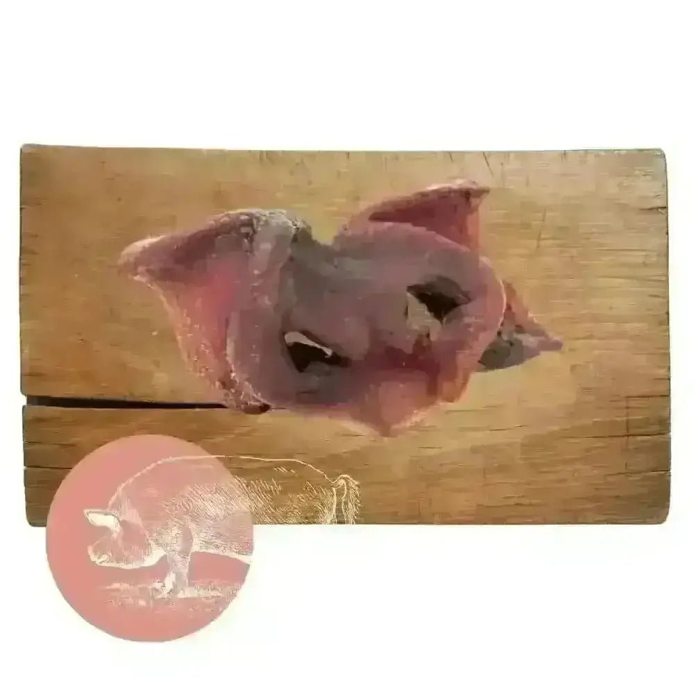Wooden cutting board with carved pig head and air-dried pork snouts design