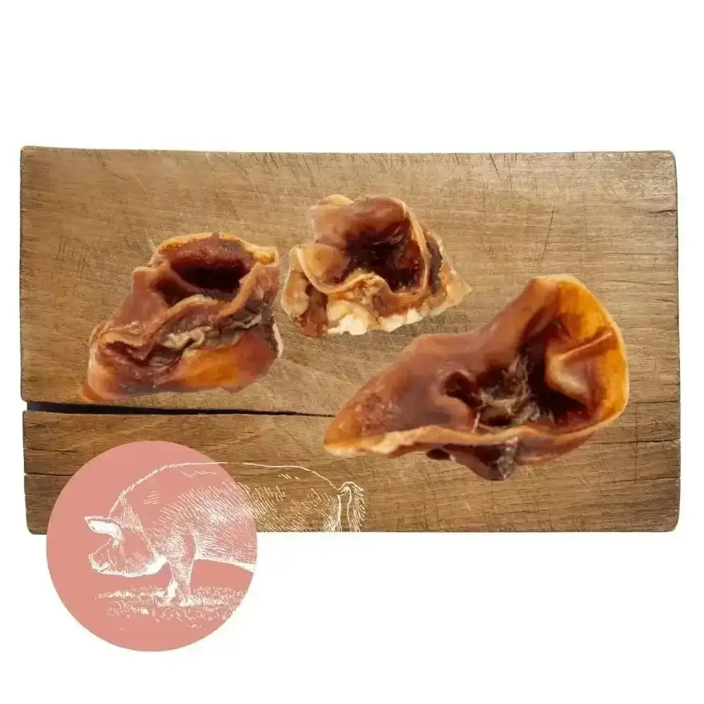 Pork Crunch natural dog chew: pig ear treat with brown skin and white fat on wooden board