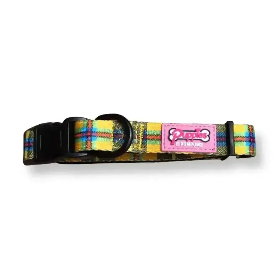 Plaid dog collar with pink and white label, black buckle, yellow background.