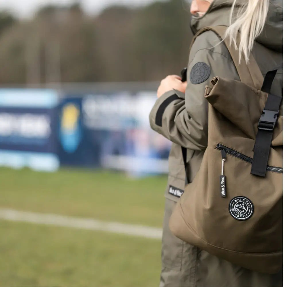 Olive green backpack with black straps, Raincoat and Changing Robe logo