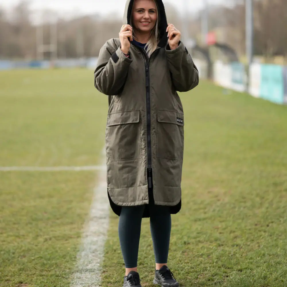 Olive green hooded changing robe parka with black accents and pockets