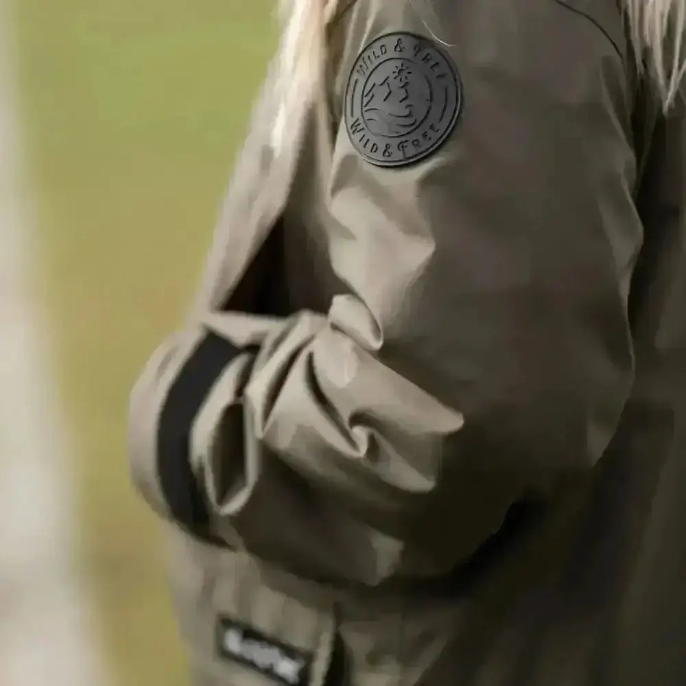 Olive green puffer changing robe with logo patch and drawstring hem