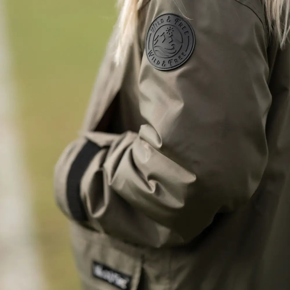 Olive green puffer changing robe with logo patch and drawstring hem