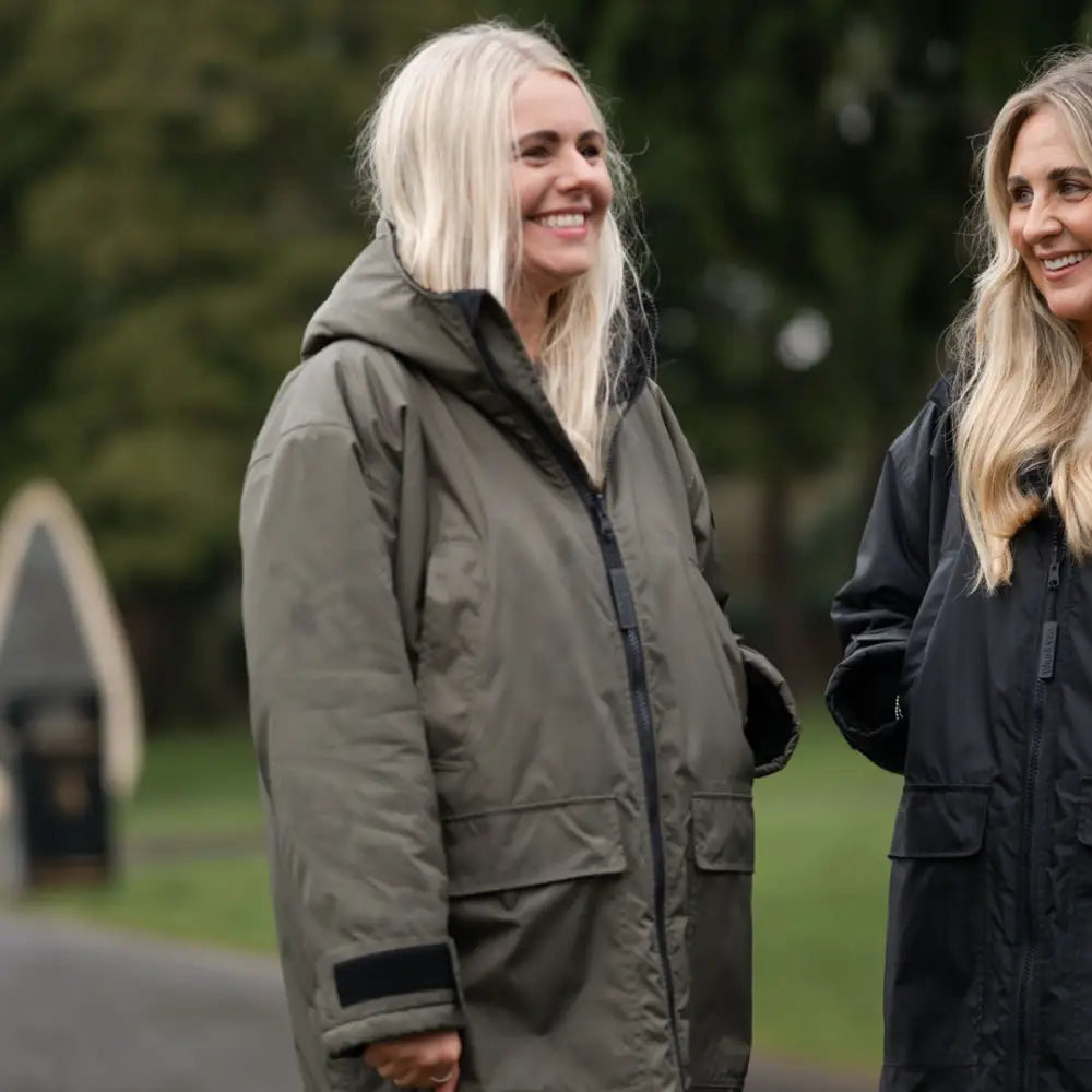 Olive green puffer changing robe with black accents and hood