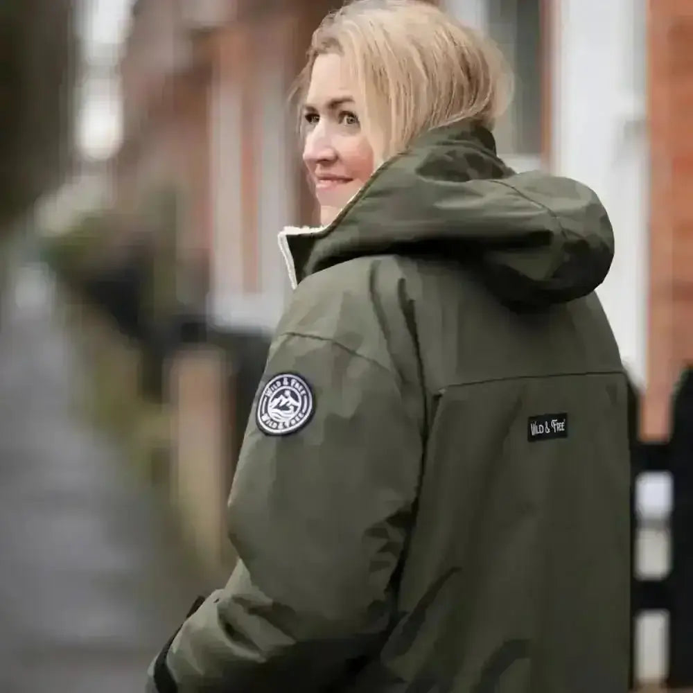 Olive green changing robe puffer jacket with white fur trim