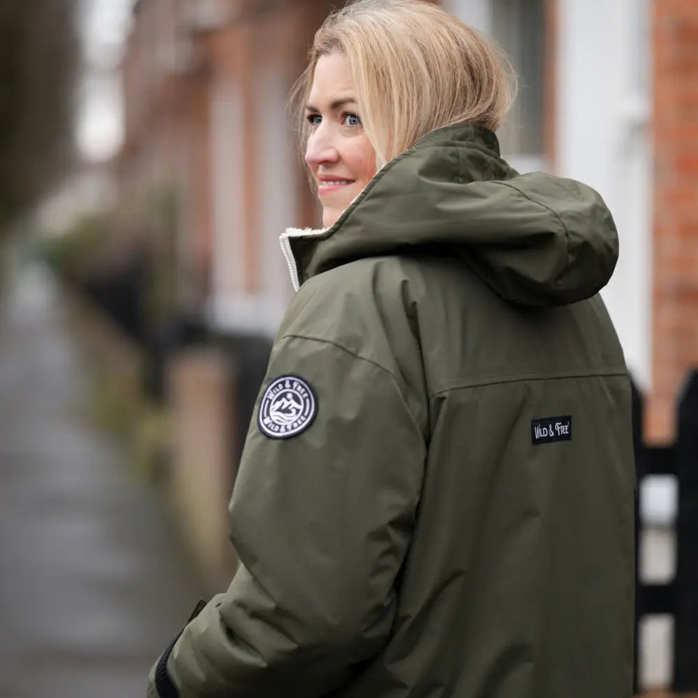 Olive green changing robe puffer jacket with white fur trim