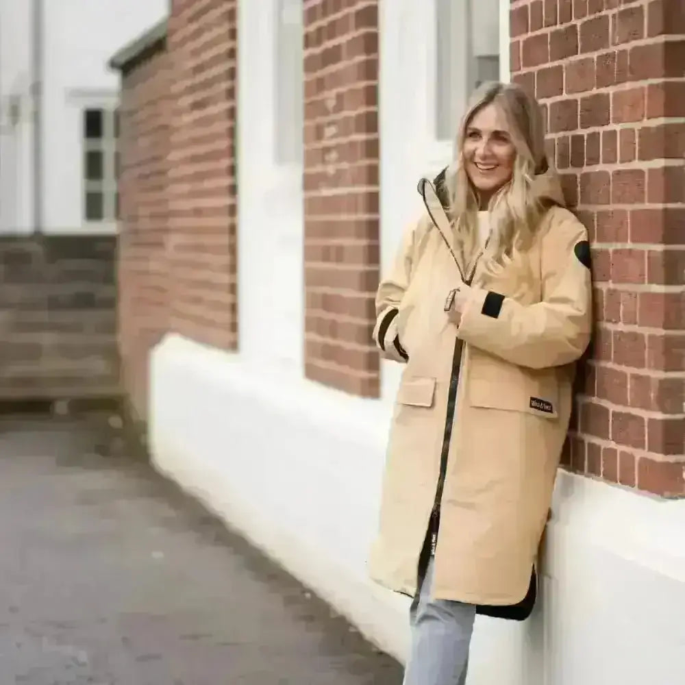 Beige Canada Goose down jacket with black accents as changing robe