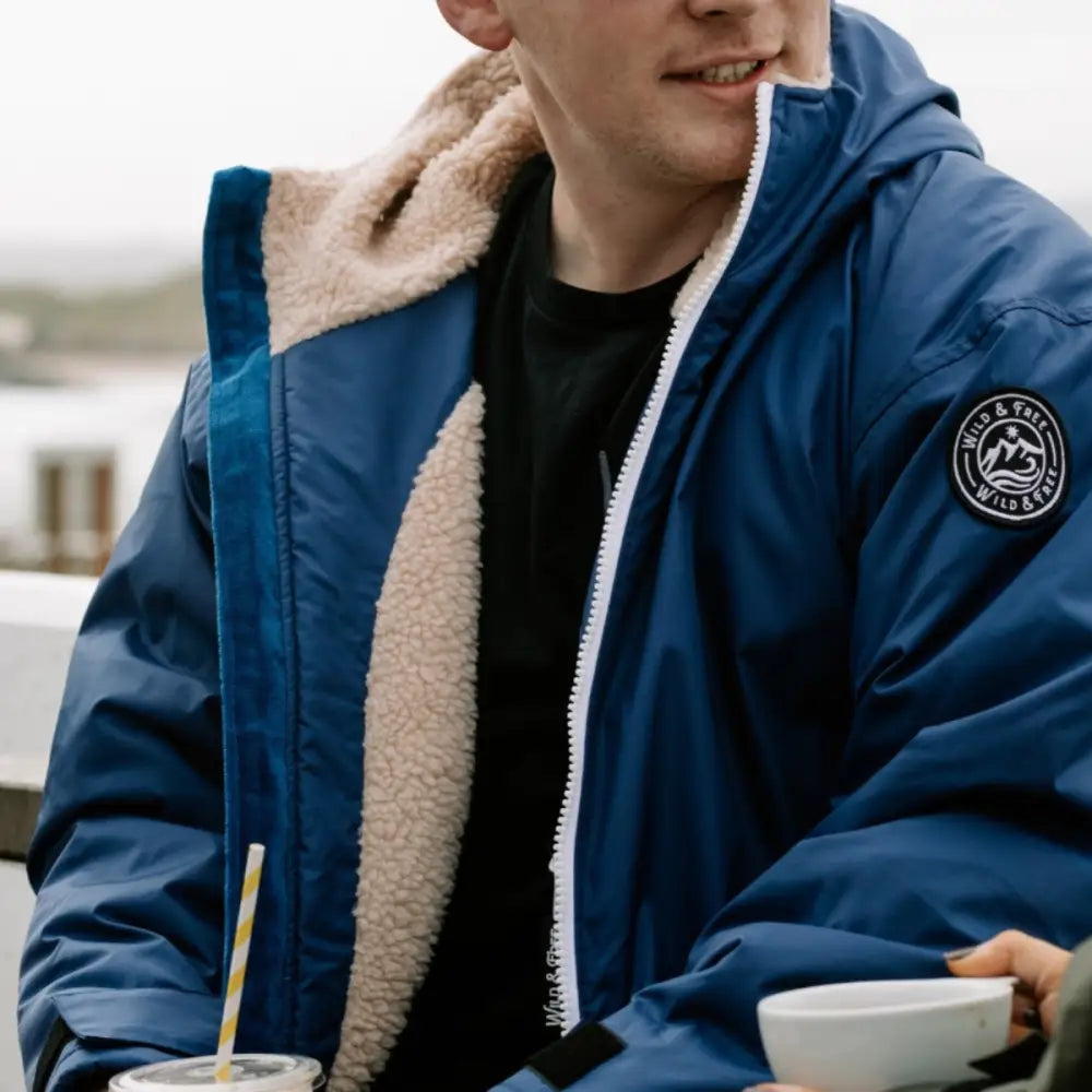 Navy Cobe changing robe with blue shearling-lined jacket and hill & valley logo